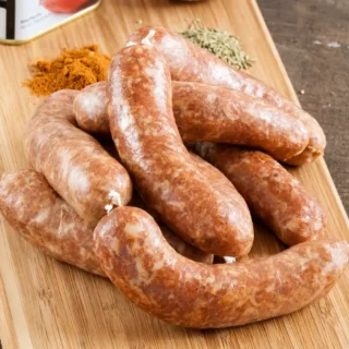 Fresh Homemade Spanish Chorizo sausages arranged on a wooden board.