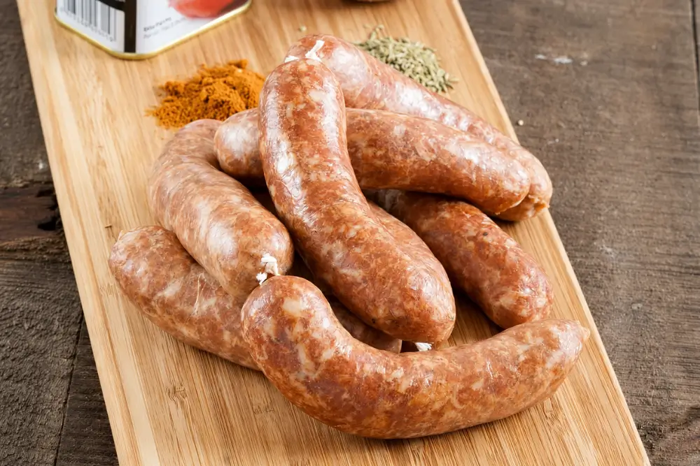 Fresh Homemade Spanish Chorizo sausages arranged on a wooden board.