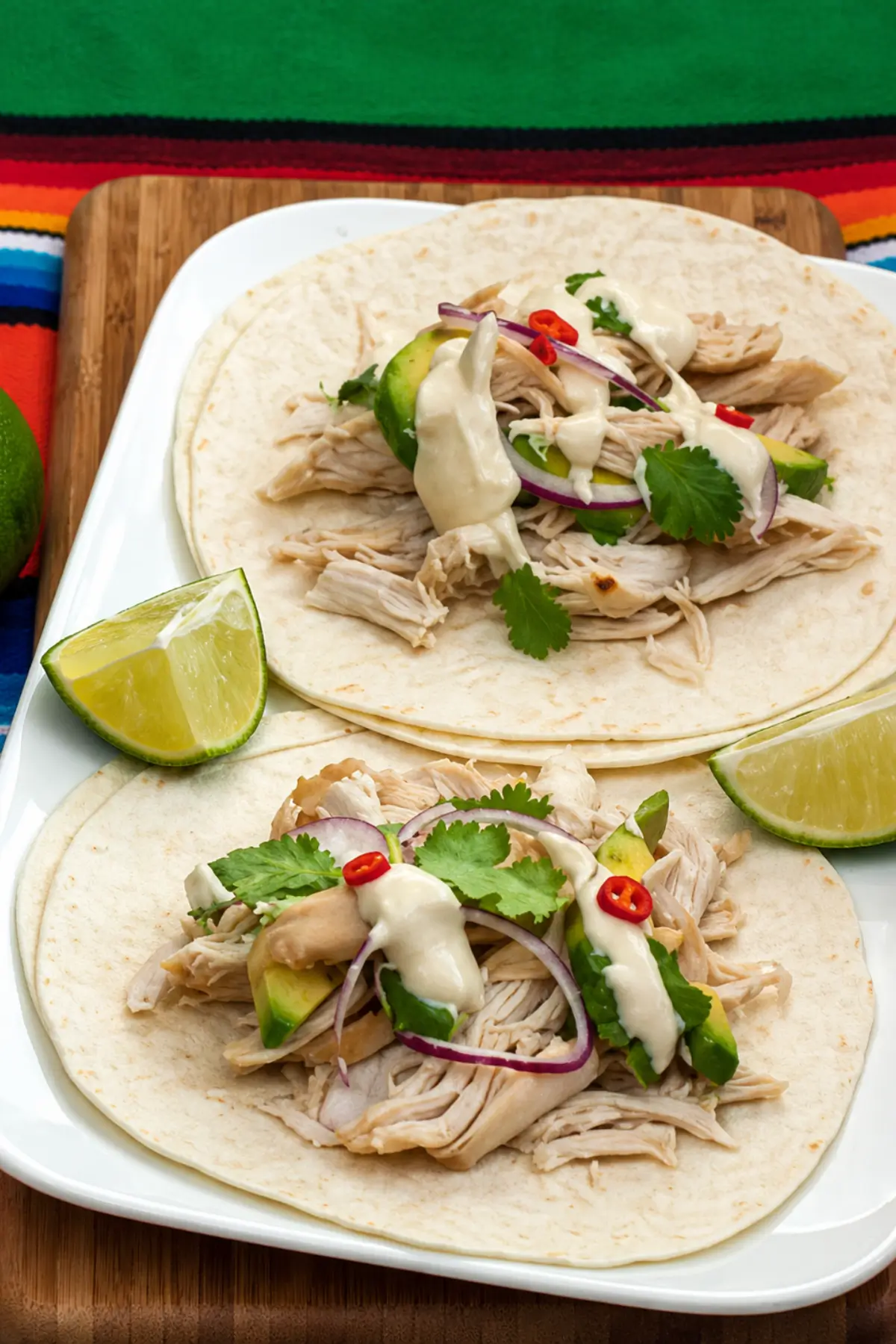 Soft tortillas filled with shredded chicken, avocado slices, and a creamy lime dressing.