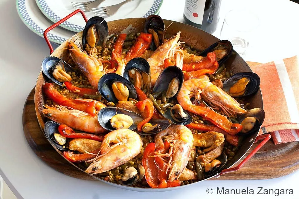 Traditional Spanish paella with prawns, mussels, and red peppers.