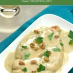 Chicken Gorgonzola with creamy sauce, walnuts and parsley on a plate.