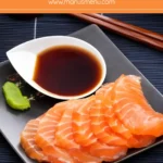 Salmon sashimi served with ponzu sauce and wasabi.