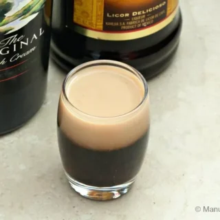 Close-up of a Baby Guinness layered shot highlighting the contrast between Baileys and Kahlua.