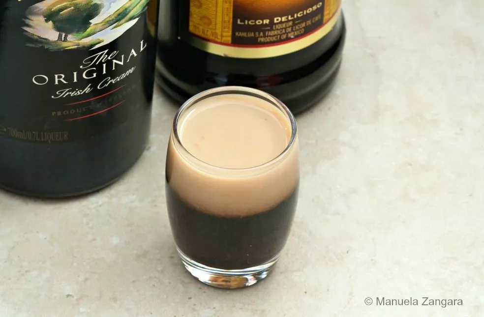Close-up of a Baby Guinness layered shot highlighting the contrast between Baileys and Kahlua.