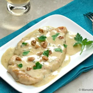 Close-up of Chicken Gorgonzola with creamy sauce, walnuts and parsley.