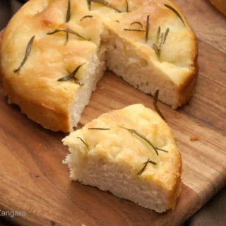 Close-up of cut wedge revealing airy interior and lightly crisp edges.