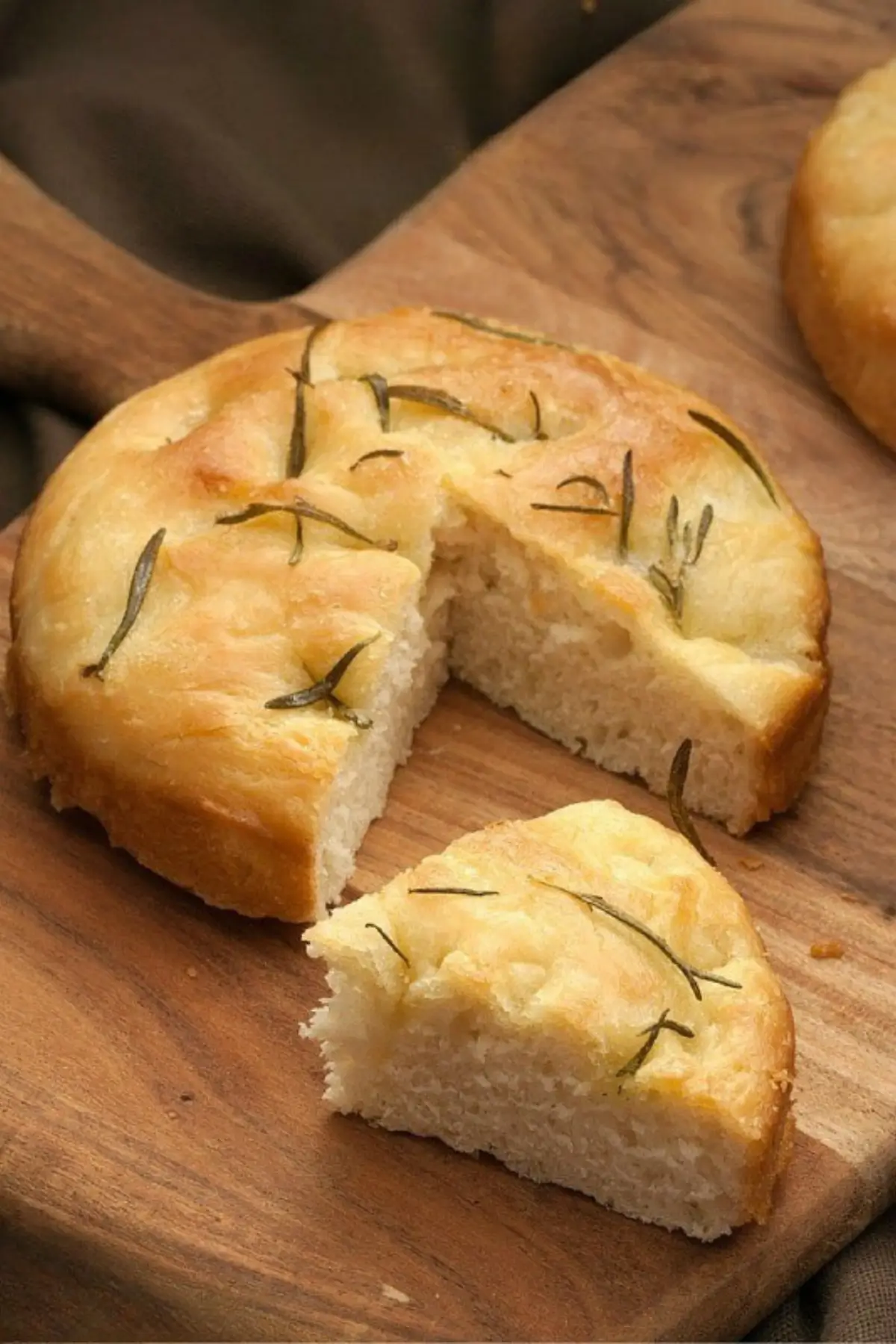 Round flatbread with rosemary and olive oil baked until golden on top.