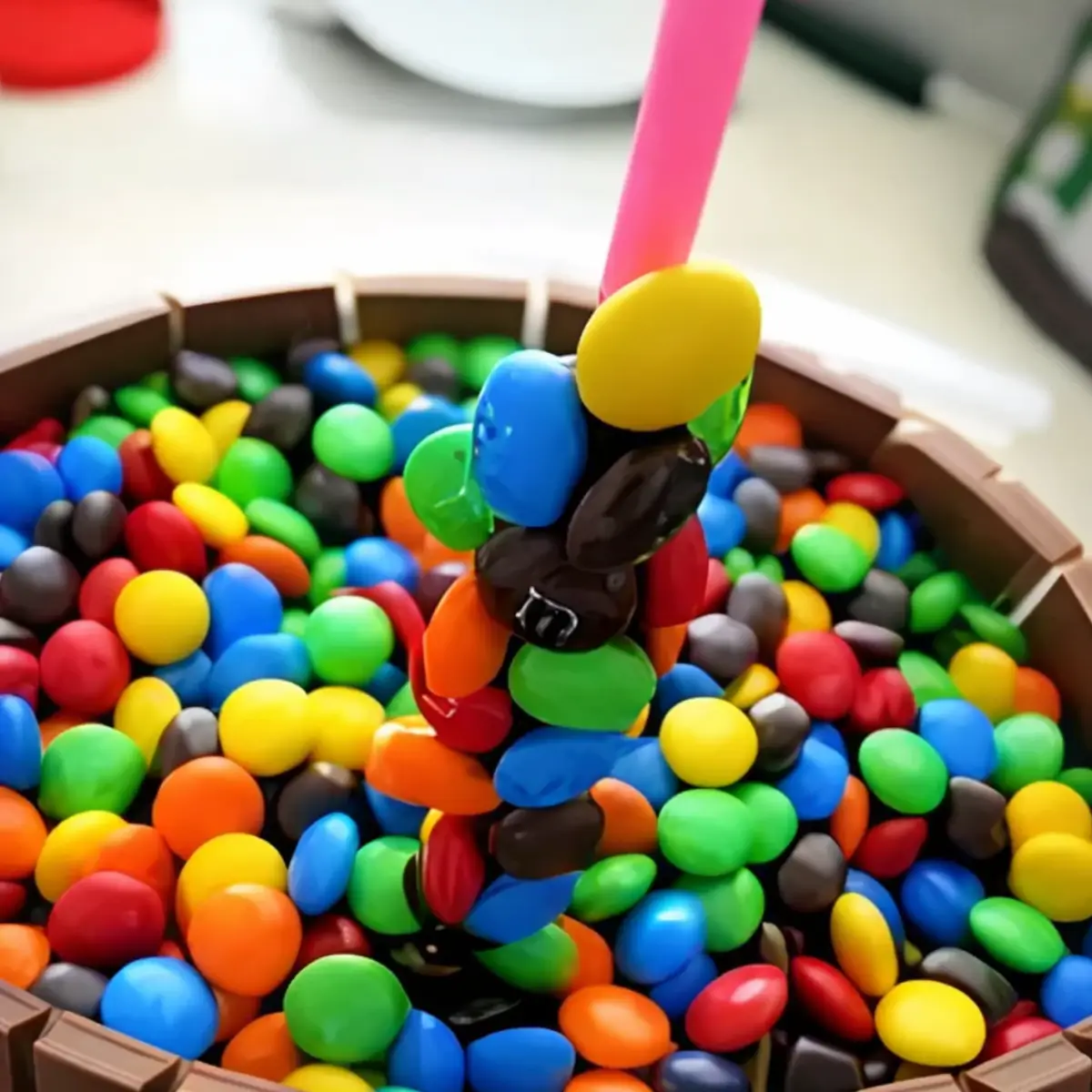Close-up of sweets attached along a stick to create a floating candy effect on the cake.
