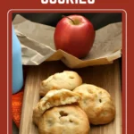 Pasta frolla cookies filled with apple, one cut open to show the tender apple centre.