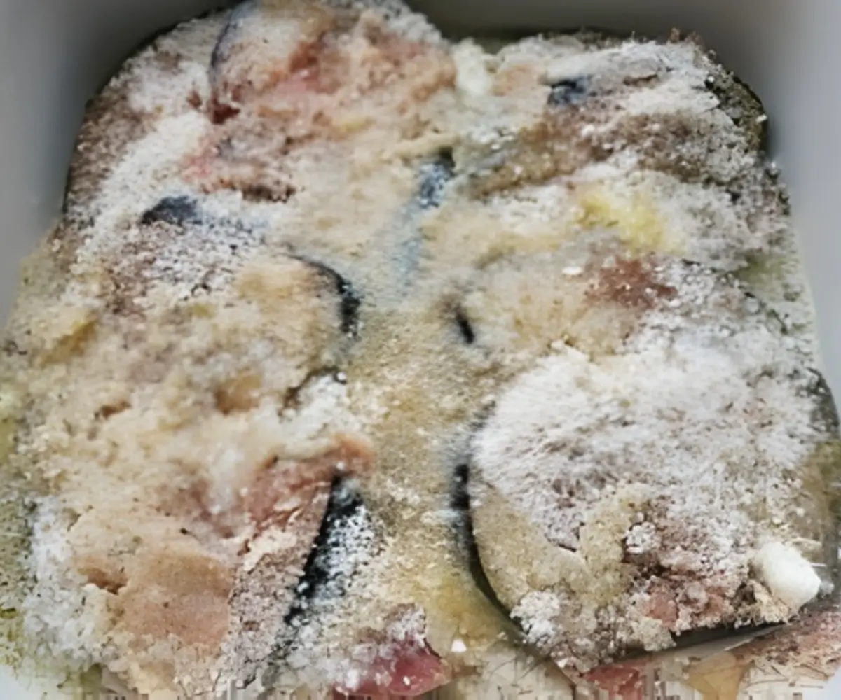 Final breadcrumb-coated layer of the eggplant bake before the eggs are added.