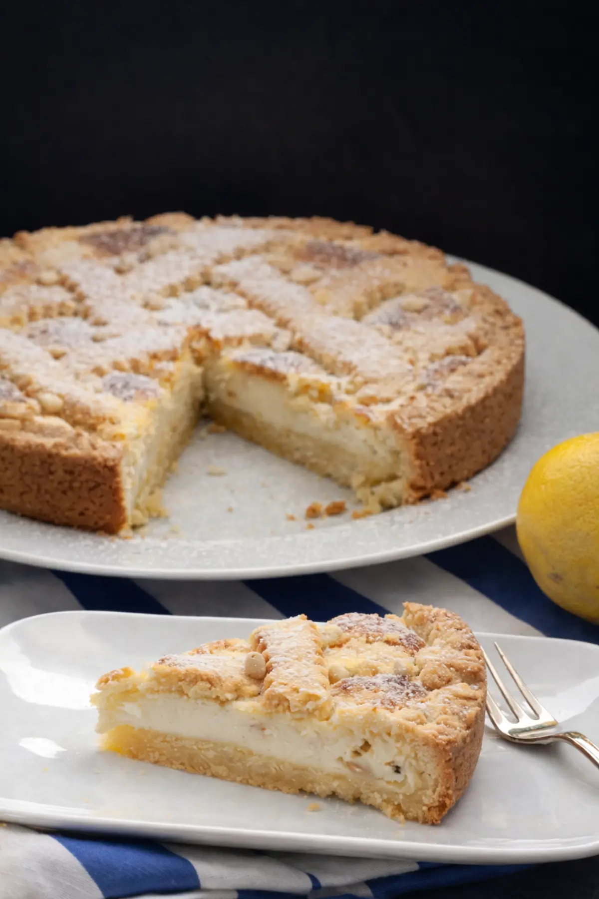 Pine Nut Cake sliced open showing creamy semolina filling and crumbly crust.