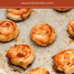 Baked Ham and Cheese Pinwheels on a baking tray.