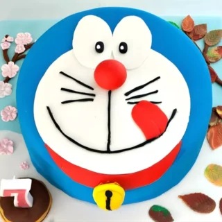 Overhead photo of Doraemon birthday cake on decorated fondant board.