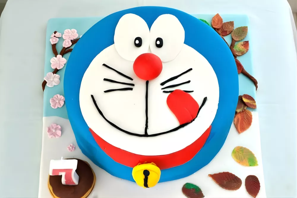 Overhead photo of Doraemon birthday cake on decorated fondant board.