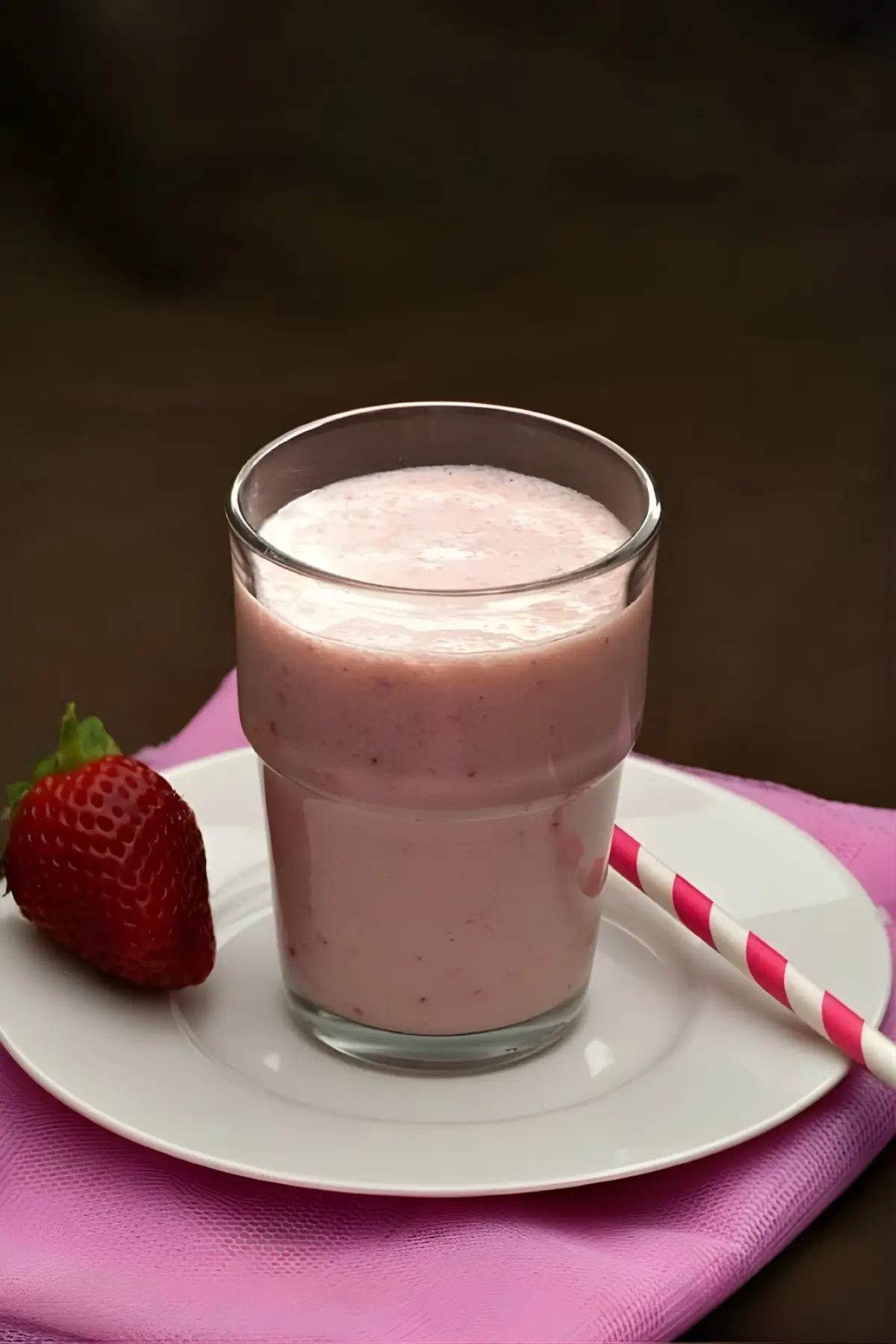 Pineapple strawberry apple smoothie served in a glass.
