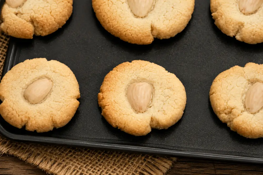 Almond Shortbread Cookies cooling on a baking tray after baking.