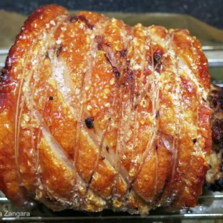 Golden-brown roast pork with perfect crackling fresh from the oven.