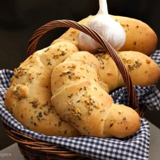 Italian garlic croissants served in a bread basket.