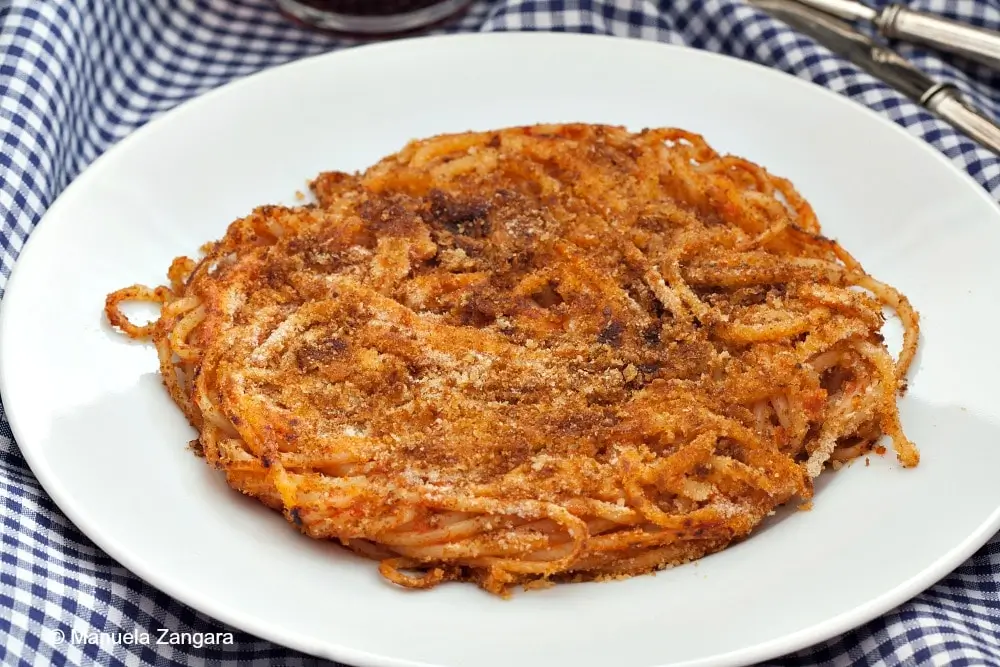 Golden fried spaghetti cake served on a plate.