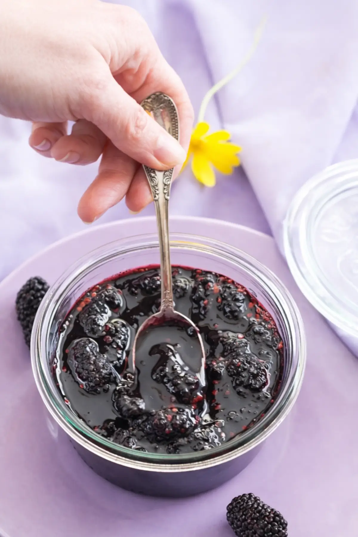 Mulberry jam with whole berries in a glass jar.