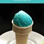 Blue Gelato al Puffo scoop in a wafer cone.