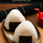 Close-up of two nori-wrapped rice balls on a rustic ceramic plate.