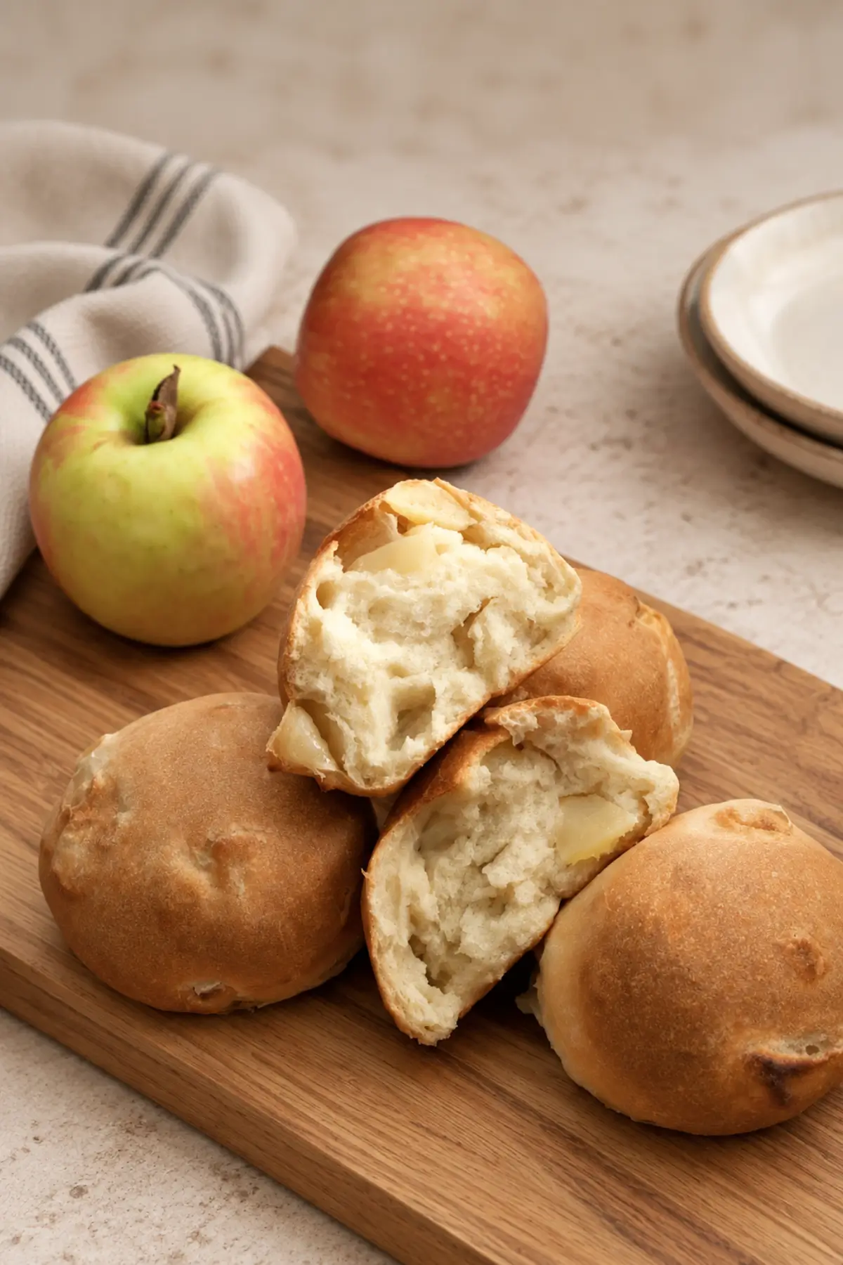 Baked apple rolls with two cut open to show the soft apple-filled centre.