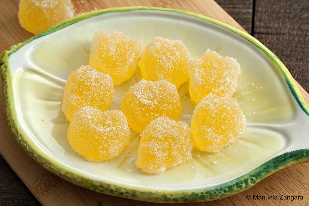 Close-up of orange and lemon jelly candies coated in sugar.