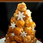 "Traditional French Croquembouche made with caramel-coated cream puffs arranged in a cone shape.