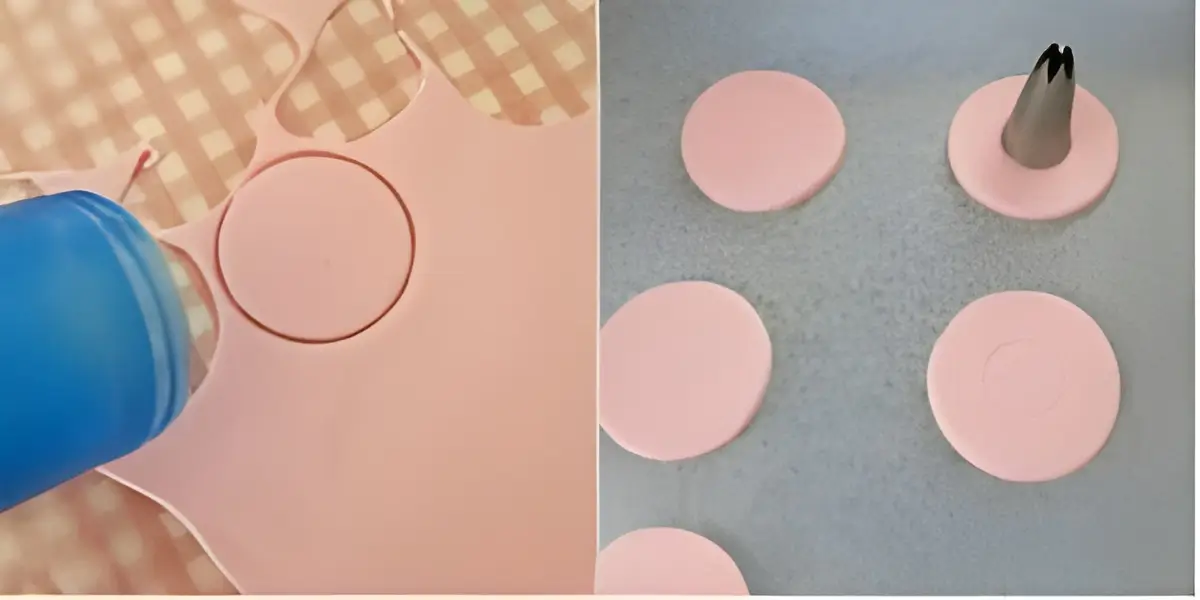 Cutting rounds of pink fondant with a circular cutter on a checkered surface.