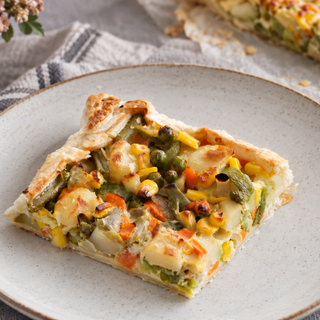 Baked vegetable pie with a golden puff pastry border and mixed vegetable filling.