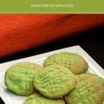 Green Buttercream Cookies with golden edges served on a white square plate.