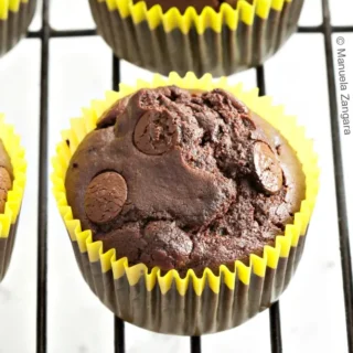 Top view of dairy-free chocolate muffins showing domed tops and chocolate chips.
