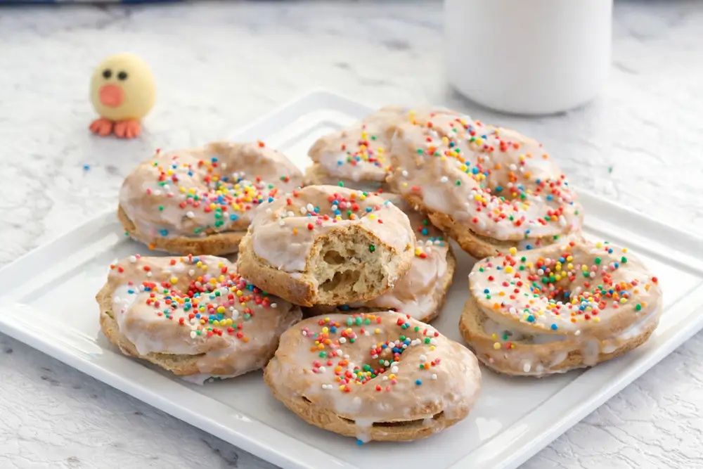 Top view of Easter taralli arranged on a serving plate with sprinkles.