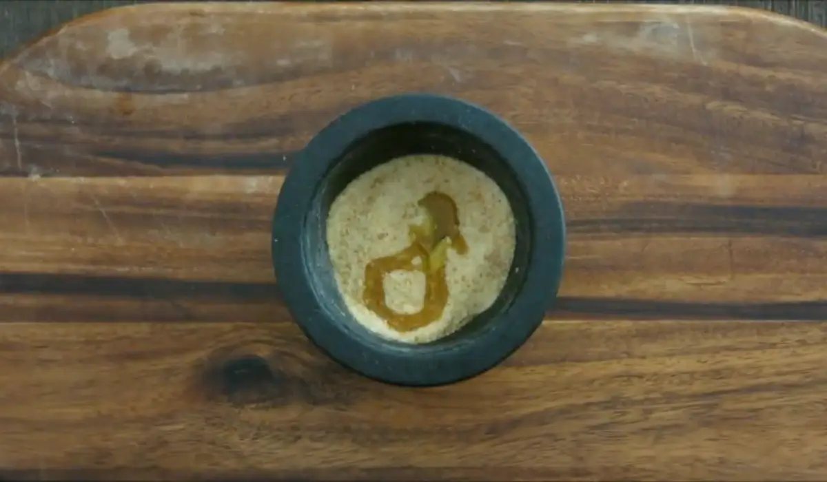 Breadcrumbs with crushed garlic and olive oil in a mortar.