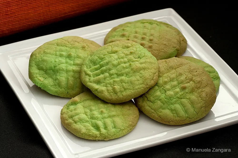 Close-up of soft green vanilla cookies with lightly browned tops.