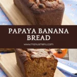 Papaya banana bread loaf with golden crust and macadamias on top.
