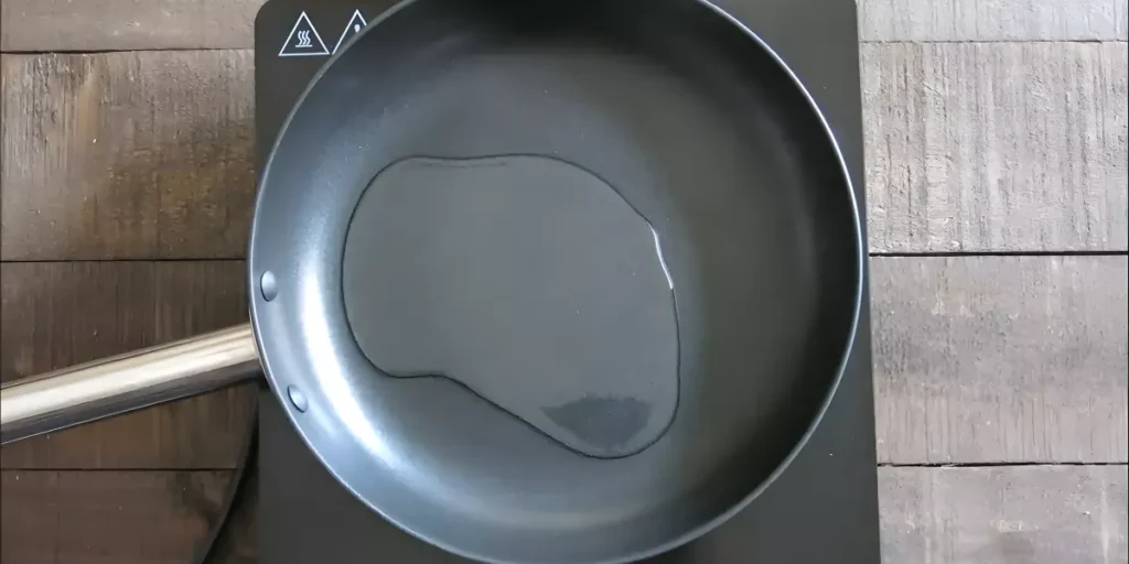 Oil heating in a wok on the stovetop.