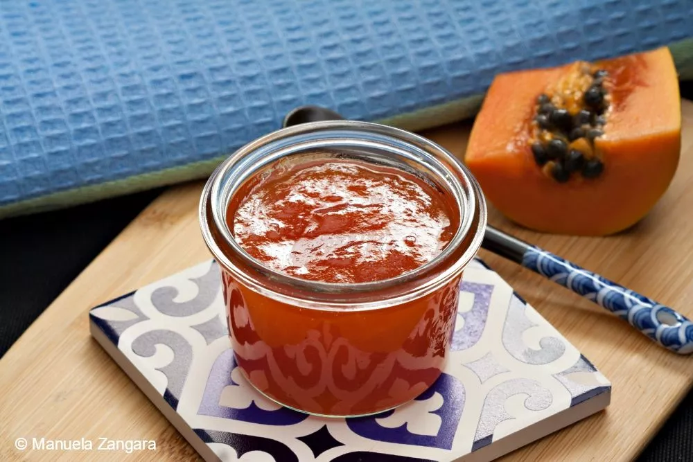 Homemade Papaya Jam in a small glass jar.