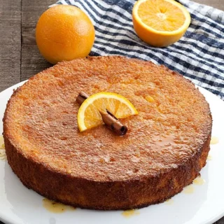 Traditional Italian orange polenta cake with orange slice and cinnamon on top.
