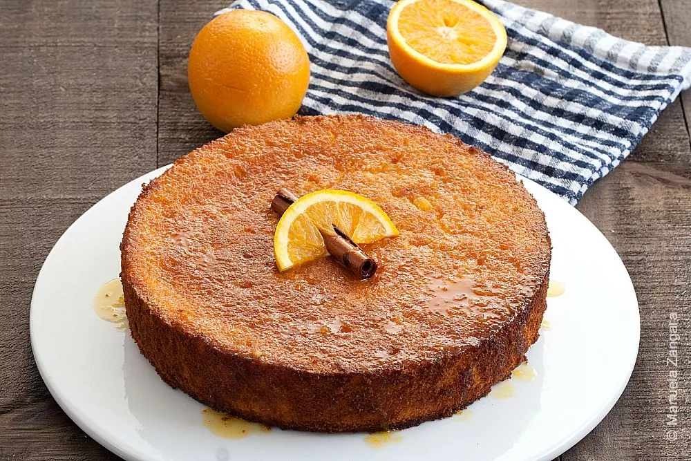 Traditional Italian orange polenta cake with orange slice and cinnamon on top.