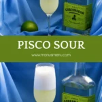 Chilled cocktail with creamy foam served in a tall glass with fresh lime on the side.