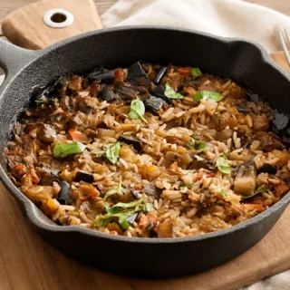 One-Pot Mediterranean Eggplant Rice served in a cast-iron skillet.