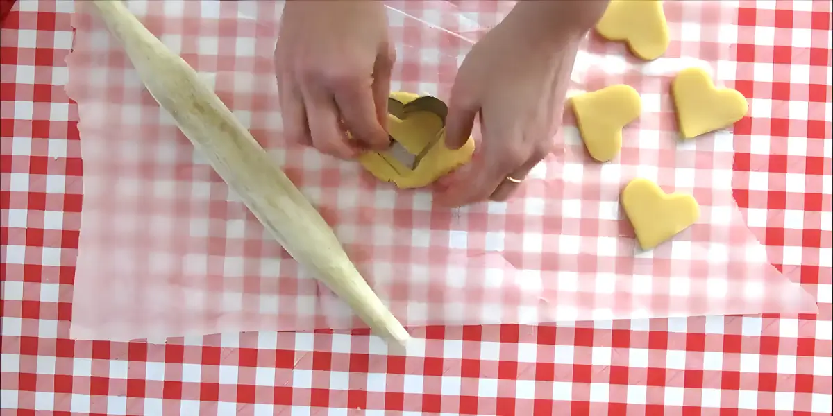 Rolled dough pressed into a tart tin and trimmed at the edges.