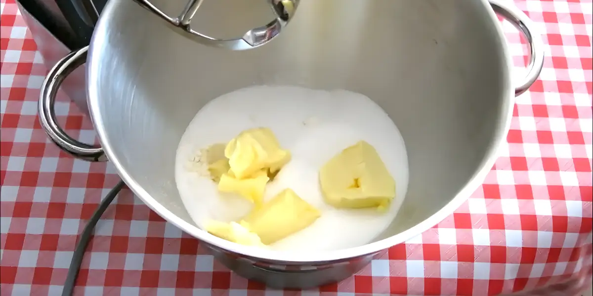 Butter and sugar placed in a mixing bowl before combining.