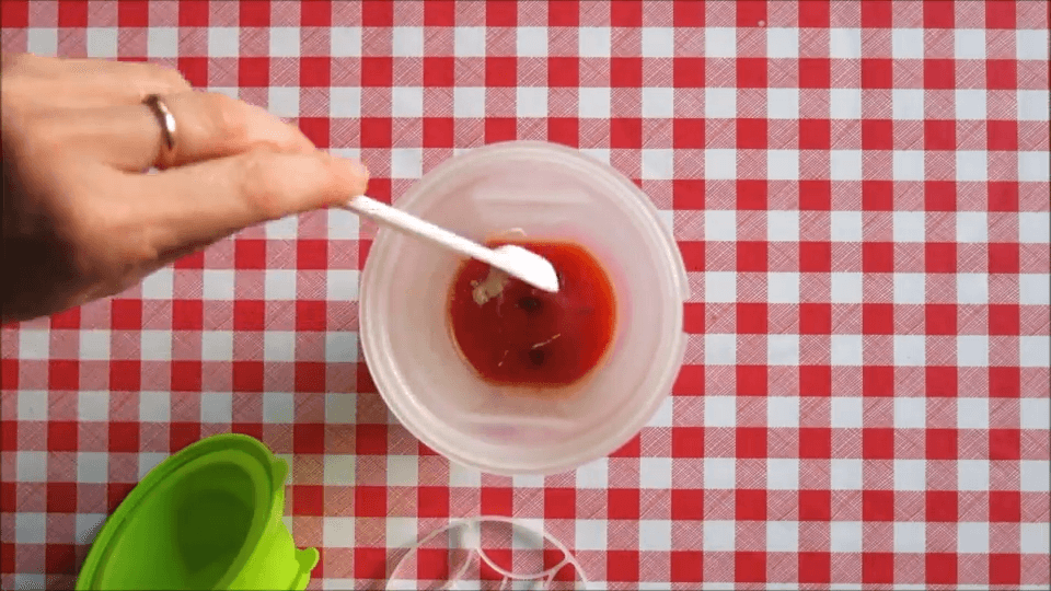 Adding horseradish and spices into tomato juice for Bloody Mary mix.