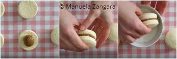 Filling Alfajores with Dulce de Leche and pressing cookies together.