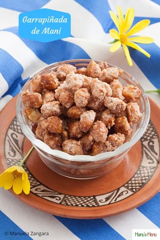 Bowl of Garrapiñada de Maní, Argentinian-style candied peanuts served on a plate.