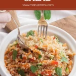 Asian Quinoa Salad being served with a fork, showing fluffy grains and fresh herbs.