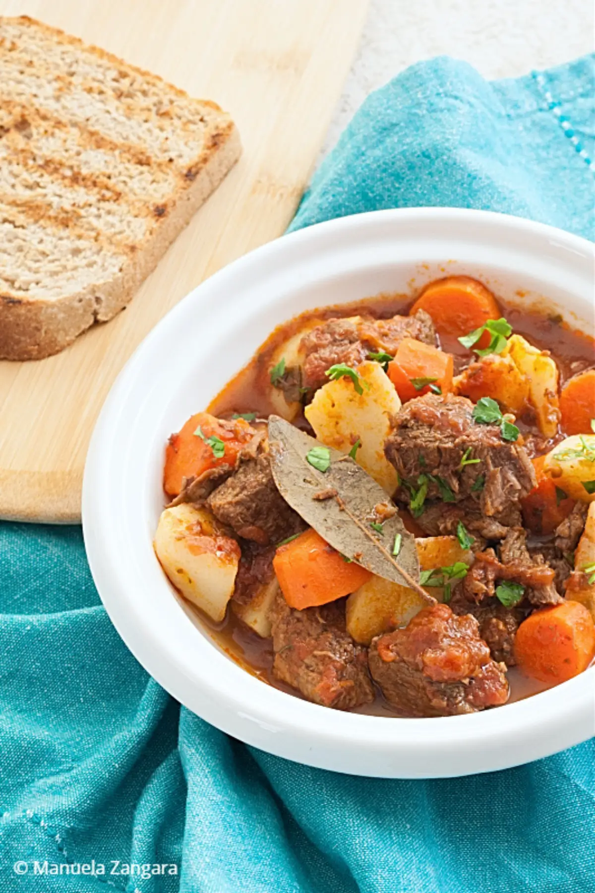 Beef stew with carrots and potatoes in tomato sauce.